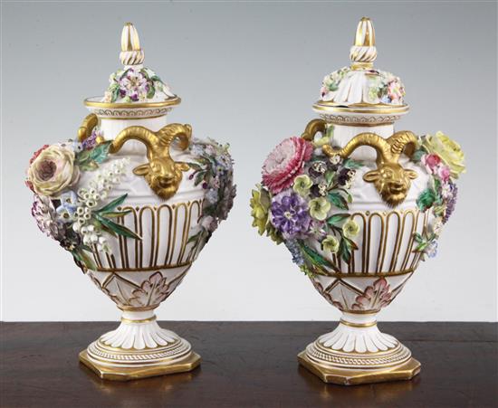 A pair of John Bevington floral encrusted twin handled vases, late 19th century, 24.5cm, damage to covers